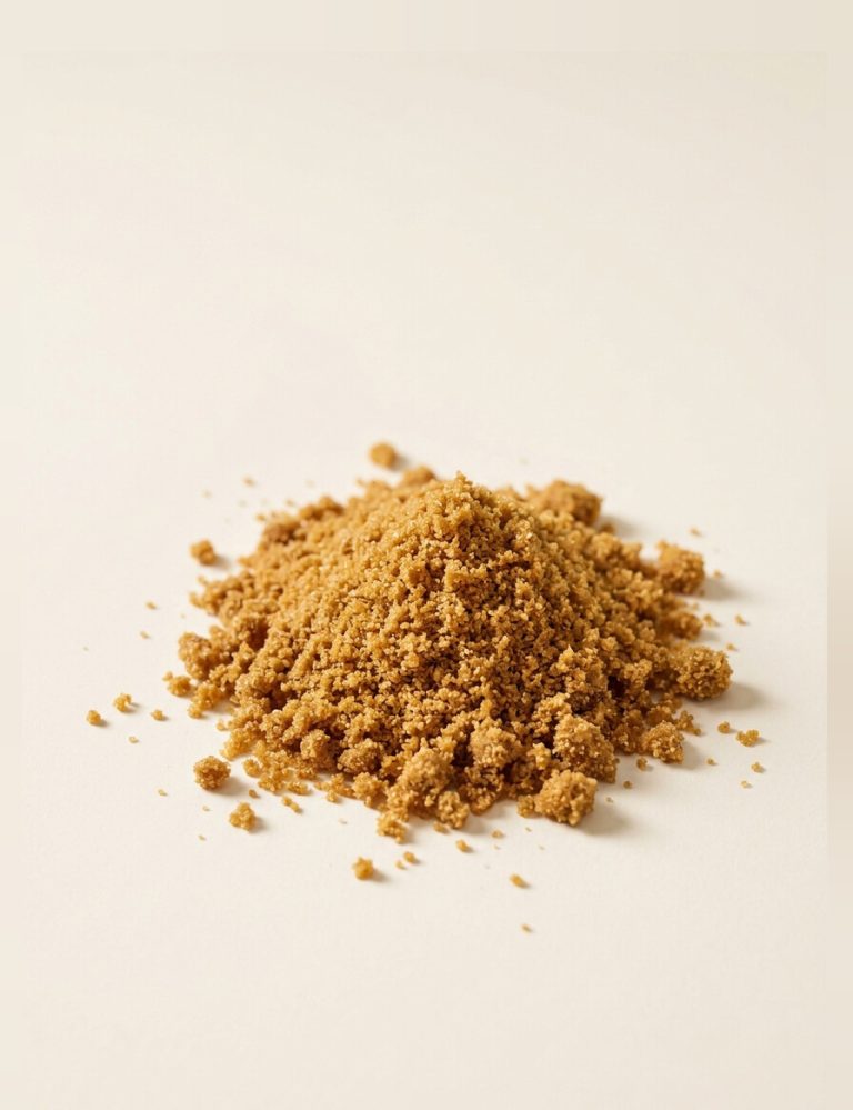 A heap of coarse golden-brown unrefined sugarcane powder.